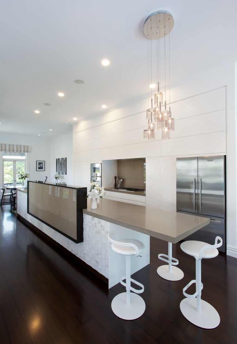 A rectangular privacy element on this island hides architecture, ceiling, countertop, home, house, interior design, kitchen, light fixture, product design, table, gray