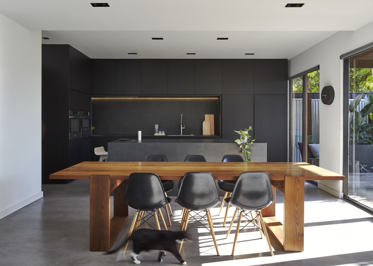 Although the cabinets in this kitchen appear black, countertop, furniture, interior design, kitchen, table, black, gray, white