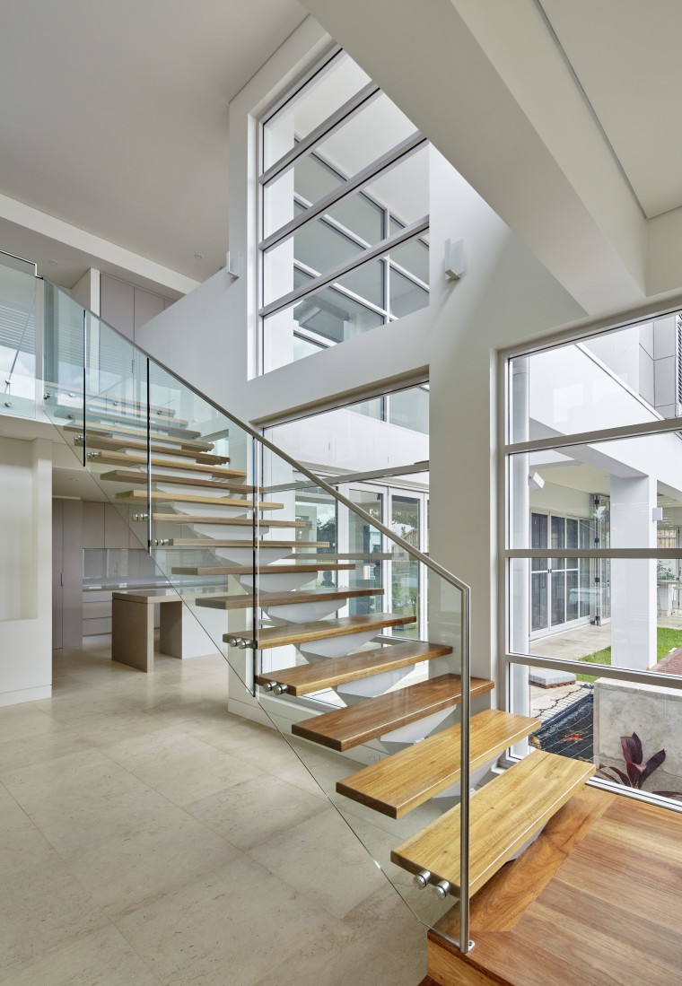 Soaring double-height voids create a light, airy interior architecture, condominium, daylighting, estate, floor, glass, handrail, home, house, interior design, real estate, stairs, gray