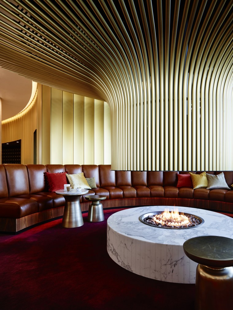 The Canberra Airport Hotel's signature round, curving theme architecture, ceiling, interior design, lighting, lobby, restaurant, table, red, brown