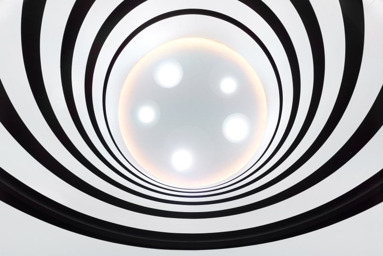 This atrium's alternating ribbons of white balustrades and black and white, circle, line, product design, spiral, white, black