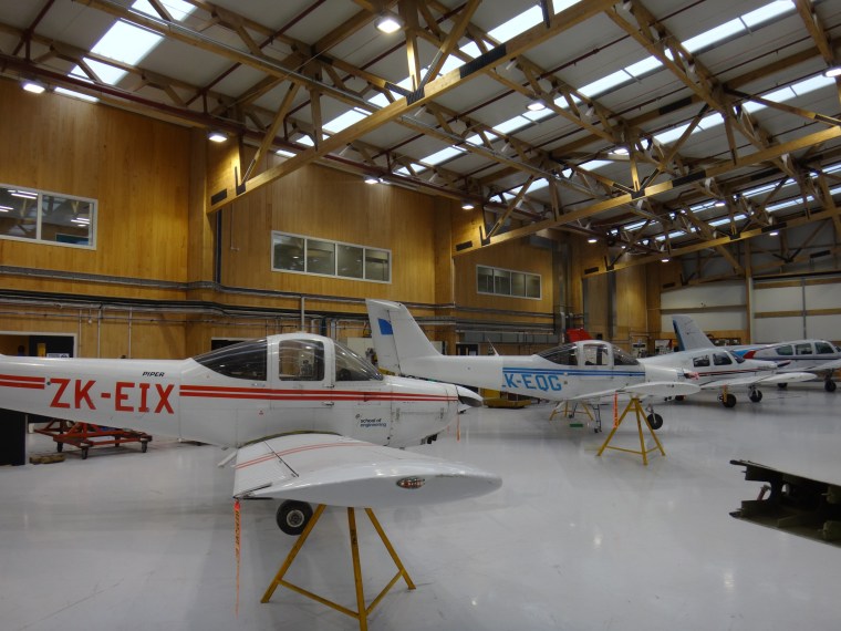 :Long-span Glulam trusses by TimberFirst combine with XLam aerospace engineering, aircraft, airplane, aviation, hangar, light aircraft, gray, brown