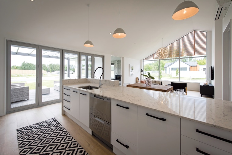 A soaring raked ceiling and expansive window wall cabinetry, countertop, cuisine classique, home, interior design, kitchen, real estate, room, window, gray