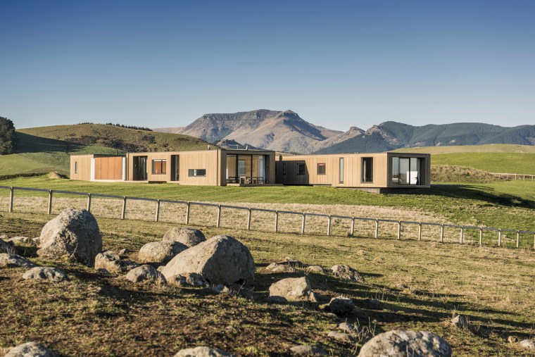 Clad in gracefully aging cedar, this home by cottage, estate, farm, farmhouse, fell, field, grassland, highland, hill, home, house, hut, landscape, mountain, mountainous landforms, pasture, property, real estate, rural area, sky, wilderness, brown