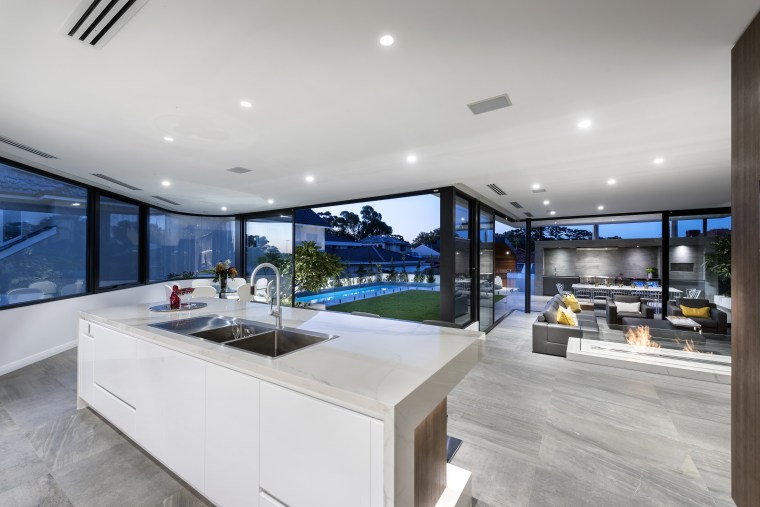 A dishwasher is integrated into the back of architecture, countertop, estate, house, interior design, kitchen, property, real estate, gray