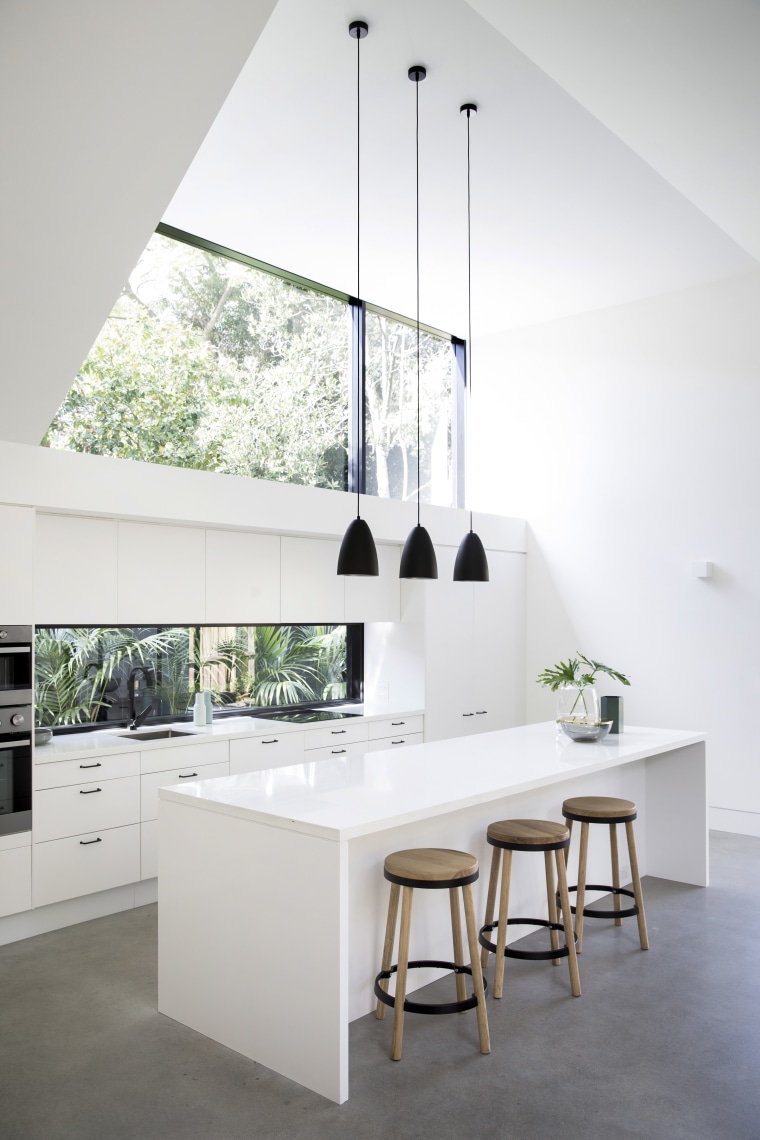 Architect Eva-Marie Prineas prioritised the owners modest renovation architecture, countertop, daylighting, floor, furniture, home, house, interior design, kitchen, product design, table, white
