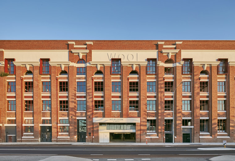 Built in 1922, the Dalgety Wool Stores is apartment, architecture, brick, building, commercial building, condominium, elevation, facade, home, landmark, mixed use, neighbourhood, property, real estate, residential area, window, teal