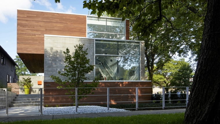 The exterior of this home comprises two materials architecture, building, facade, home, house, property, tree, black, brown