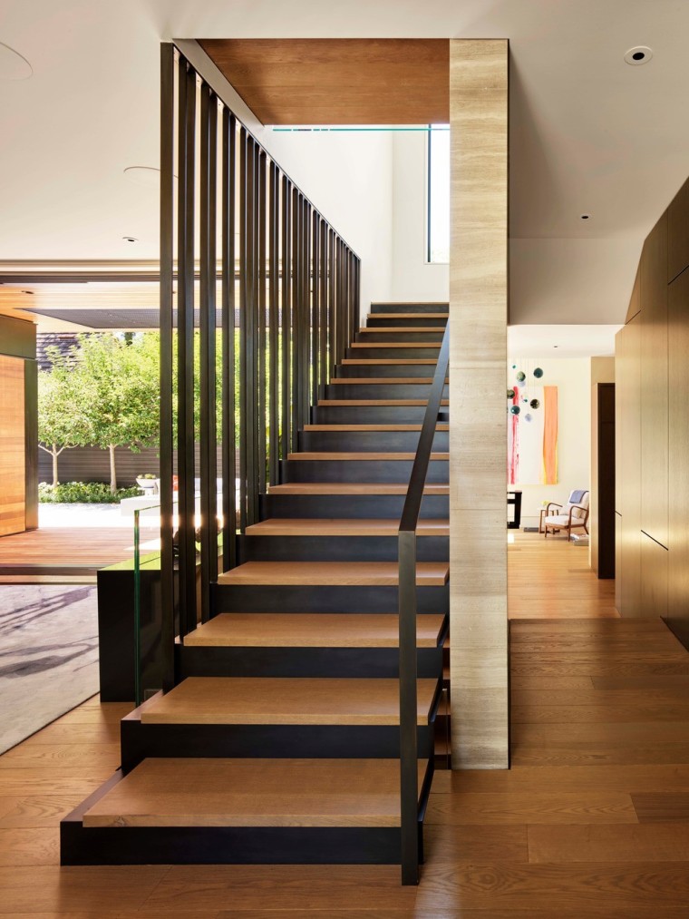 This three-storey stair separates the entertaining spaces from architecture, building, ceiling, floor, flooring, handrail, home, house, interior design, lobby, property, real estate, room, stairs, brown, white