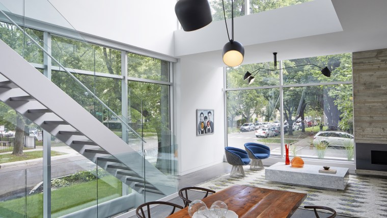 Once inside the house, the first floor erupts architecture, building, ceiling, daylighting, floor, furniture, glass, home, house, interior design, kitchen, lighting, living room, property, real estate, room, table, window, gray, white