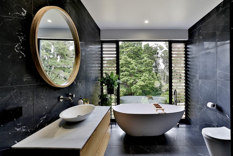 This simple yet striking bathroom lets occupants feel architecture, bathroom, bathtub, building, ceiling, ceramic, floor, flooring, furniture, home, house, interior design, marble, plumbing fixture, property, real estate, room, sink, tap, tile, wall, window, gray, black