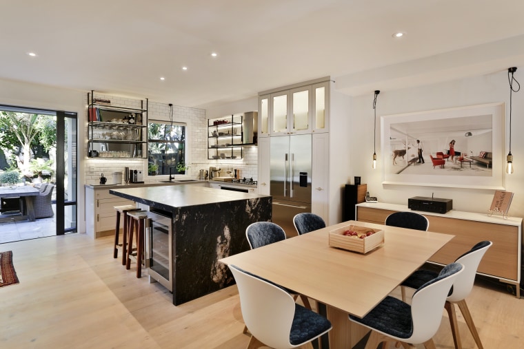There's a seamless flow from the kitchen space countertop, interior design, kitchen, property, real estate, gray