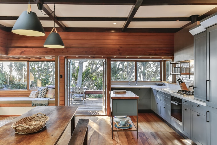 While this overall kitchen space is quite compact, architecture, beam, building, cabinetry, ceiling, countertop, daylighting, floor, flooring, furniture, hardwood, home, house, interior design, kitchen, lighting, loft, property, real estate, room, table, window, wood, wood flooring, wood stain, gray, brown