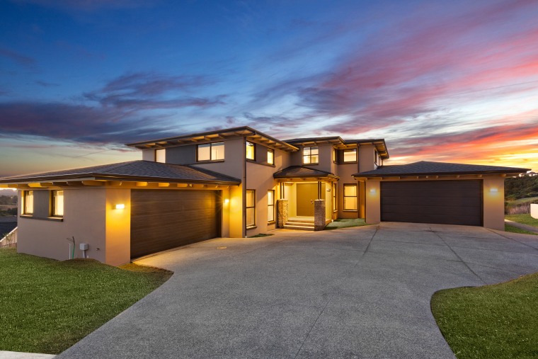 Two levels at entry, this generous-sized house by architecture, backyard, building, concrete, design, door, driveway, estate, facade, grass, home, house, interior design, land lot, landscape, landscaping, lighting, mansion, property, real estate, residential area, roof, sky, suburb, gray