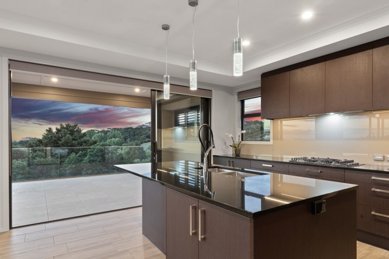 This grand three-level home by Fowler Homes South architecture, building, cabinetry, ceiling, countertop, design, floor, flooring, furniture, glass, granite, hardwood, home, house, interior design, kitchen, laminate flooring, lighting, property, real estate, room, table, tile, wood flooring, gray