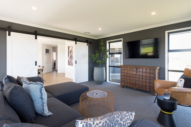 The living room is a few steps from apartment, building, coffee table, den, floor, furniture, home, house, interior design, living room, property, real estate, room, table, white