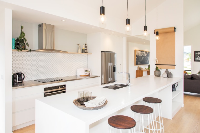 This two-storey GJ Gardner Wanaka showhome responds to architecture, building, cabinetry, ceiling, countertop, design, floor, furniture, home, house, interior design, kitchen, living room, material property, property, real estate, room, table, white