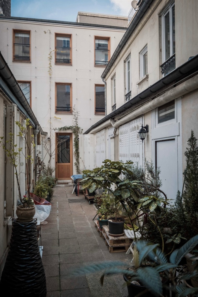 Planters were buried in order to provide enough alley, architecture, building, courtyard, facade, house, infrastructure, neighbourhood, road, street, town, tree, gray, black