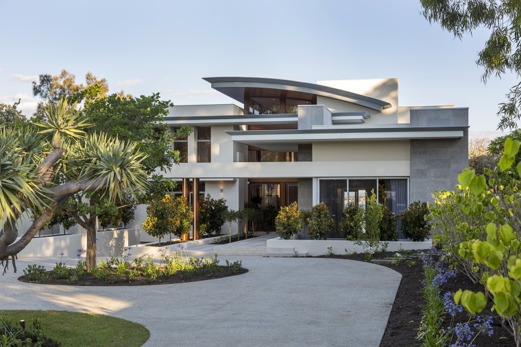 A contemporary facade reveals glimpses through to the architecture, building, estate, facade, home, house, interior design, mansion, official residence, property, real estate, residential area, roof, tree, villa, white, gray