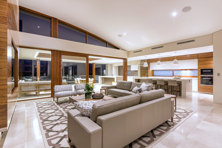 Anyone for tennis? This main living space in apartment, architecture, building, ceiling, design, estate, floor, furniture, home, house, interior design, living room, penthouse apartment, property, real estate, room, table, gray