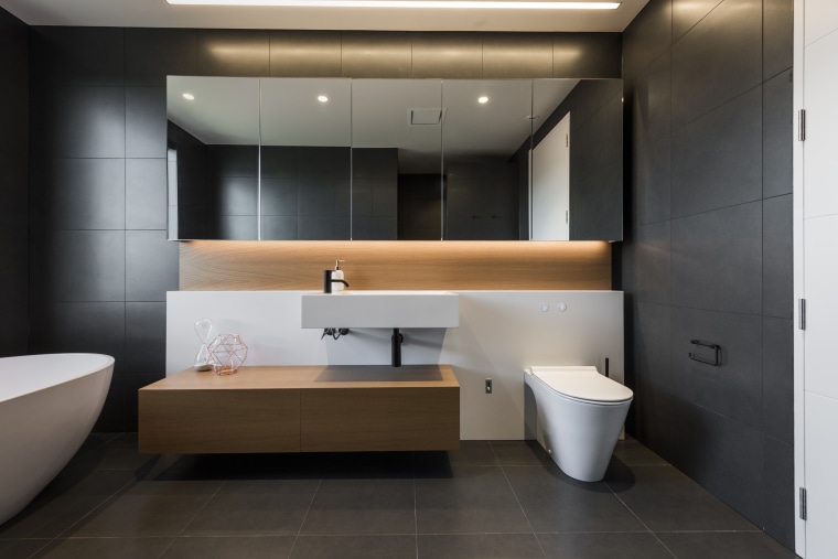 In this dramatic bathroom by professional design company bathroom, floor, flooring, interior design, black, tiles, timber vanity, Davinia Sutton