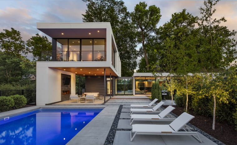 This L-shaped home by Peterssen/Keller Architecture is a architecture, backyard, facade, home, house, swimming pool, Peterssen Keller Architecture, outdoor loungers
