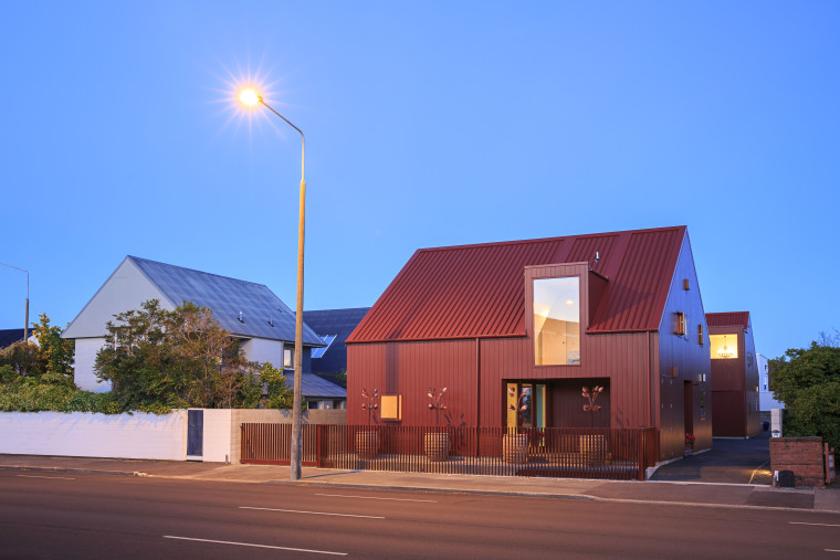 Two cottage-shaped buildings are finished in Resene Scoria architecture, building, home, house, lighting, resene, scoria, paint, lumbersider