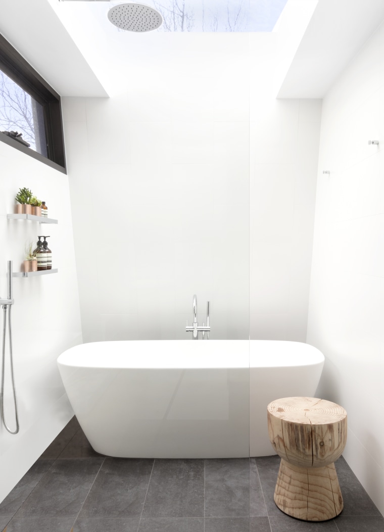 A large skylight over the shower, a soft-edged architecture, bathroom, bathtub, ceramic tiles, floor, flooring, plumbing fixtures, tap, tile, rainhead shower