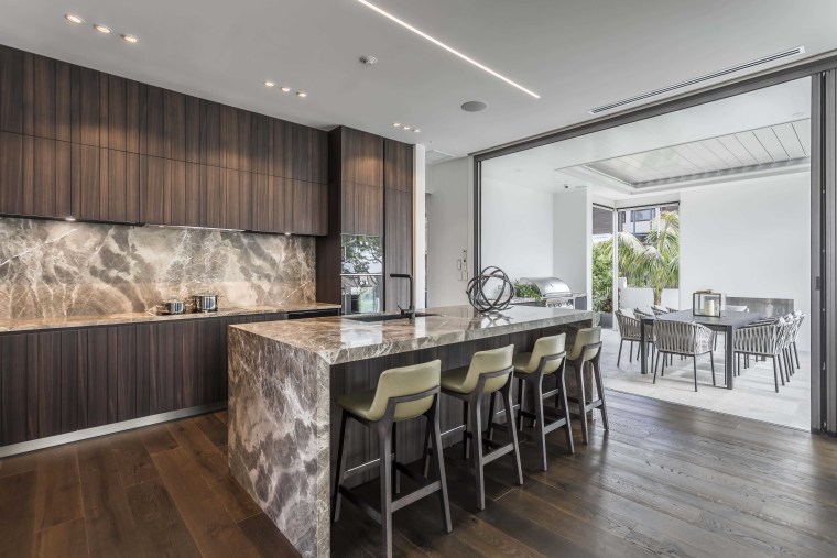 While the LED strip ceiling lighting is understated architecture, cabinetry, countertop, benthtop, design, dining room, floor, flooring, furniture, hardwood, home, house, interior design, kitchen, dining table, wood flooring, marble, Studio Italia