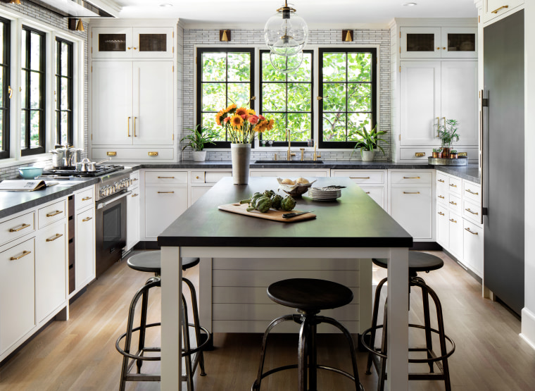 This kitchen reflects a rich materiality, with touches bar stool, cabinetry, ceiling, countertop, dining room, floor, timber flooring, furniture, home, house, interior design, kitchen, kitchen stove, stool, table, wood flooring, Studio Dearborn