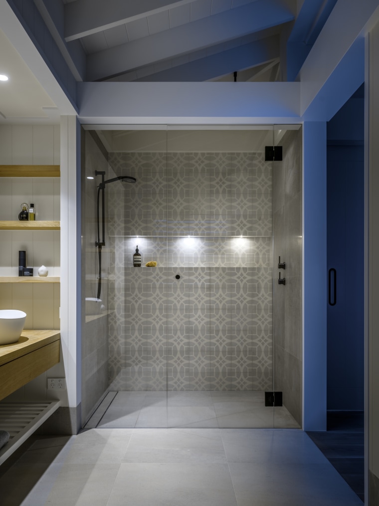 With its bold pattern tiling, black fittings and architecture, bathroom, building, ceiling, daylighting, floor, flooring, glass, home, house, interior design, plumbing fixture, property, room, tile, wall, gray