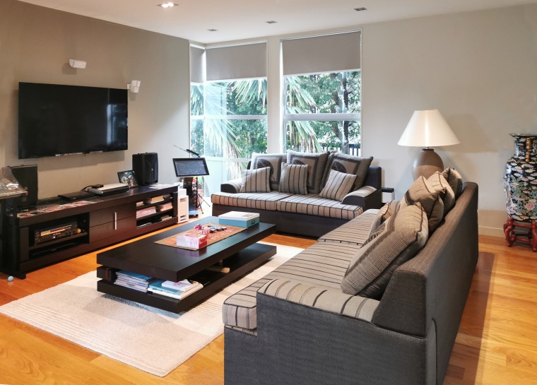 Room to move – spacious living and entertainment brown, building, ceiling, coffee table, couch, floor, flooring, furniture, hardwood, home, house, interior design, laminate flooring, living room, material property, property, real estate, room, sofa bed, table, wood flooring, gray, black