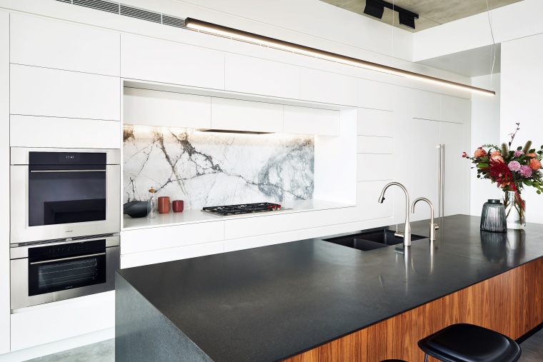 With this kitchen’s perimeter cabinetry in white, the building, cabinetry, ceiling, countertop, floor, flooring, furniture, home, home appliance, house, interior design, kitchen, kitchen appliance, kitchen stove, material property, property, room, small appliance, table, tile, white