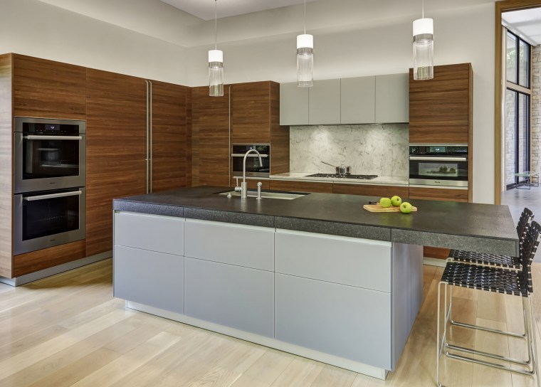 Soft, natural materials were selected for this kitchen building, cabinetry, ceiling, countertop, cuisine classique, cupboard, floor, flooring, furniture, home, home appliance, house, interior design, kitchen, kitchen appliance, kitchen stove, major appliance, material property, property, real estate, room, tile, gray, brown