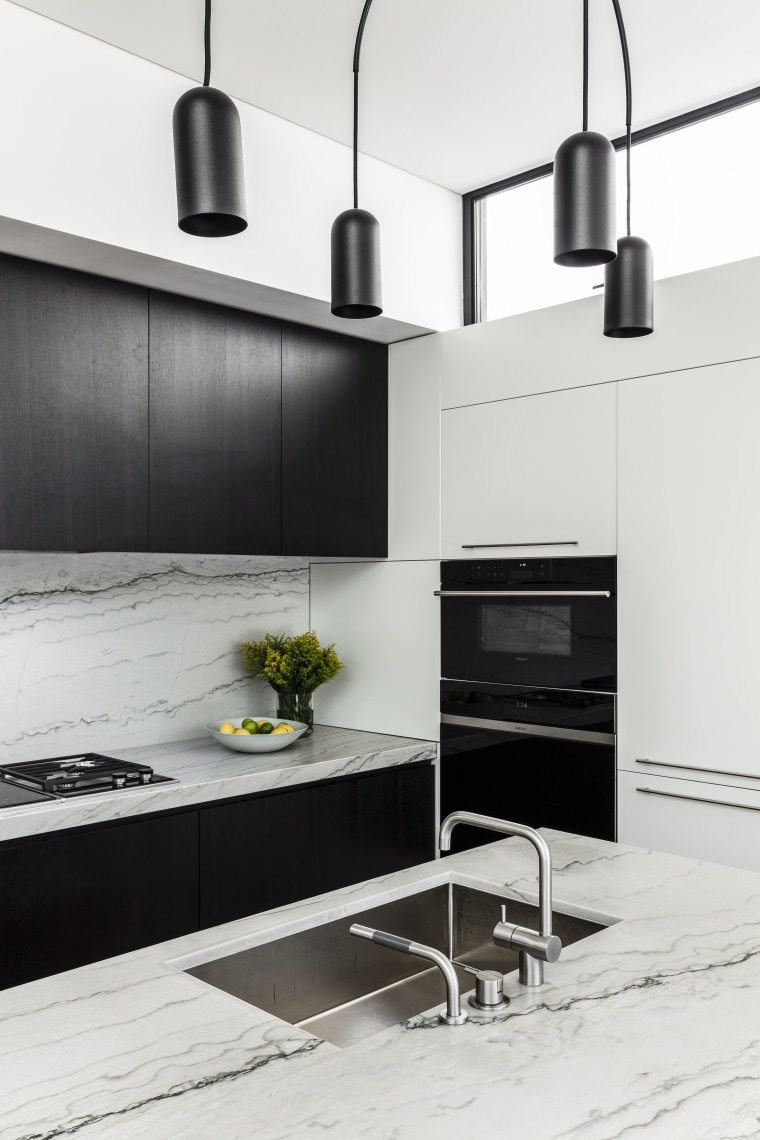 This kitchen’s minimalist lines connect with the wider white