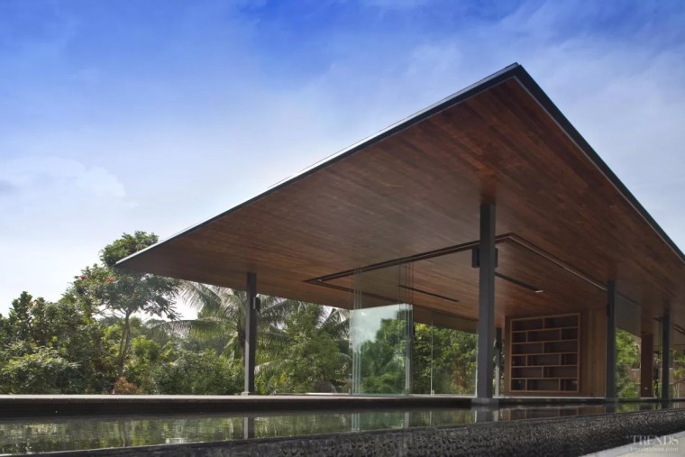 Water surrounds all sides of this living pavilion architecture, barn, building, facade, farmhouse, home, house, property, real estate, roof, rural area, shade, sky, tree, teal, black