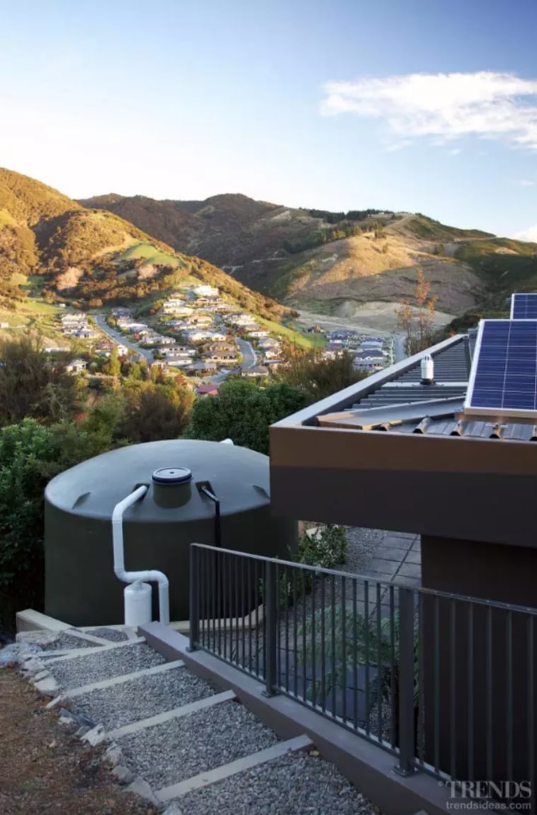 A grey-water sump recycles water from the showers, architecture, building, daylighting, handrail, home, house, mountain, mountain range, property, real estate, residential area, roof, room, sky, slope, black, white