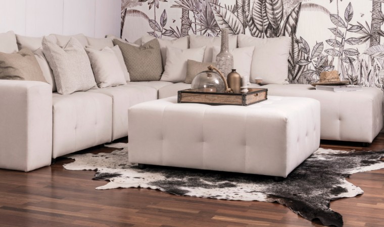Furniture that is in constant use needs a beige, chair, coffee table, couch, floor, flooring, furniture, interior design, laminate flooring, leather, living room, ottoman, room, sofa bed, table, wall, wood flooring, gray