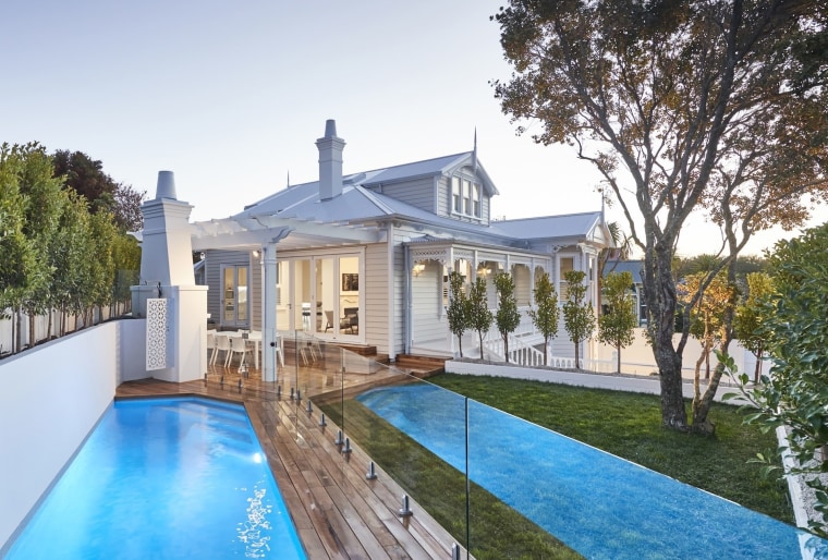 A traditional-style pergola frames this villa’s outdoor dining home, house, mansion, swimming pool, villa, white, Leuschke Kahn Architects, renovation
