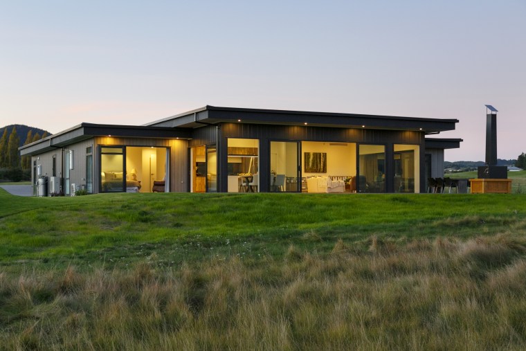 Low on the land but with great visual architecture, building, estate, facade, farmhouse, grass, home, house, land lot, landscape, property, real estate, residential area, rural area, sky, gray