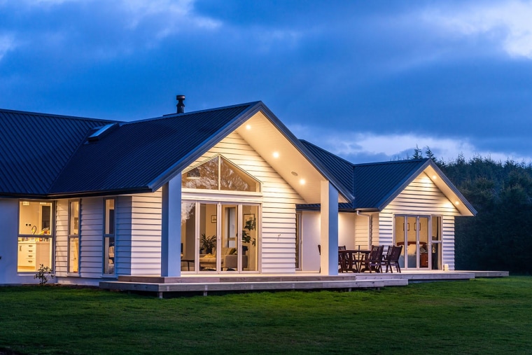 Bold and beautiful - this modern homestead is cottage, elevation, estate, facade, farmhouse, home, house, log cabin, property, real estate, roof, shed, siding, sky, window, blue