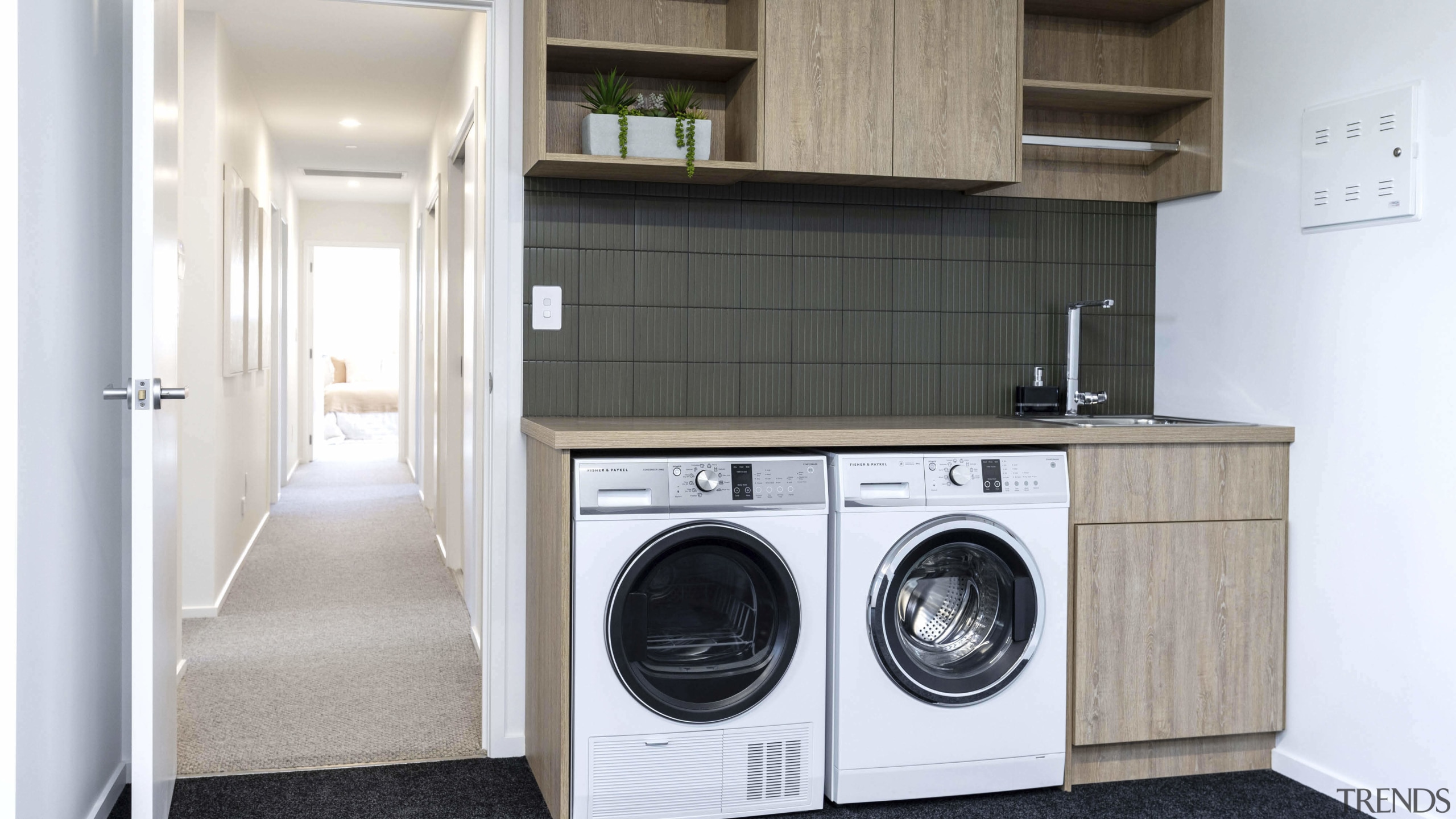 The garage and laundry showing the connecting bedroom/bathroom 