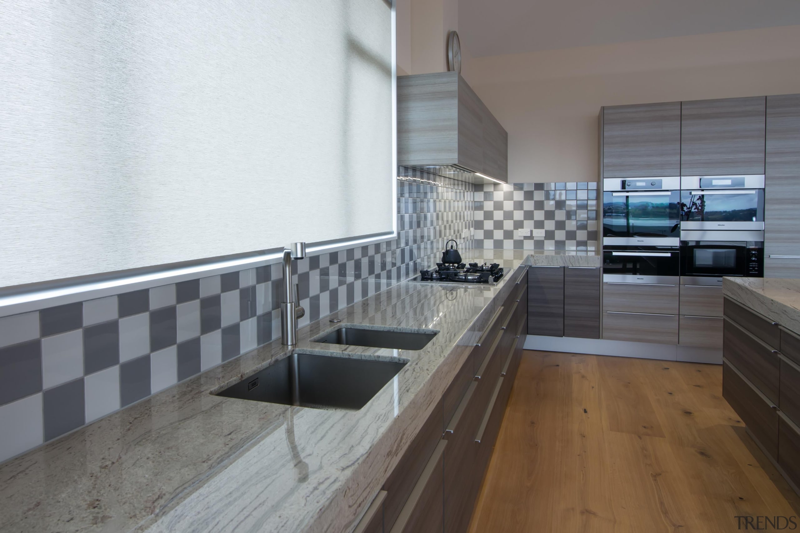 A kitchen with twice the features - double countertop, floor, flooring, interior design, kitchen, real estate, tile, gray, white