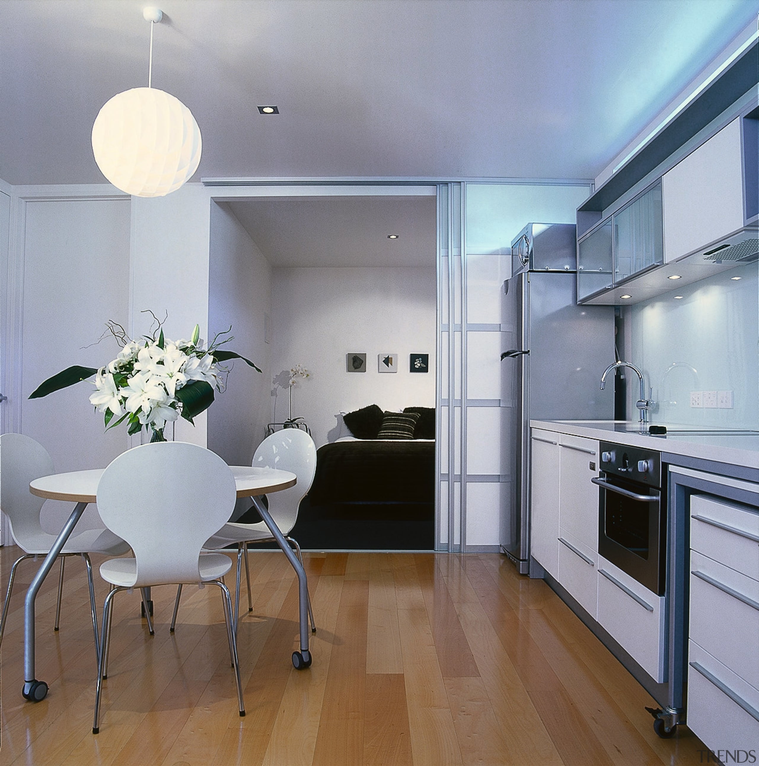 Kitchen and dining area with white cabinetry, white apartment, ceiling, countertop, floor, flooring, interior design, kitchen, real estate, room, gray