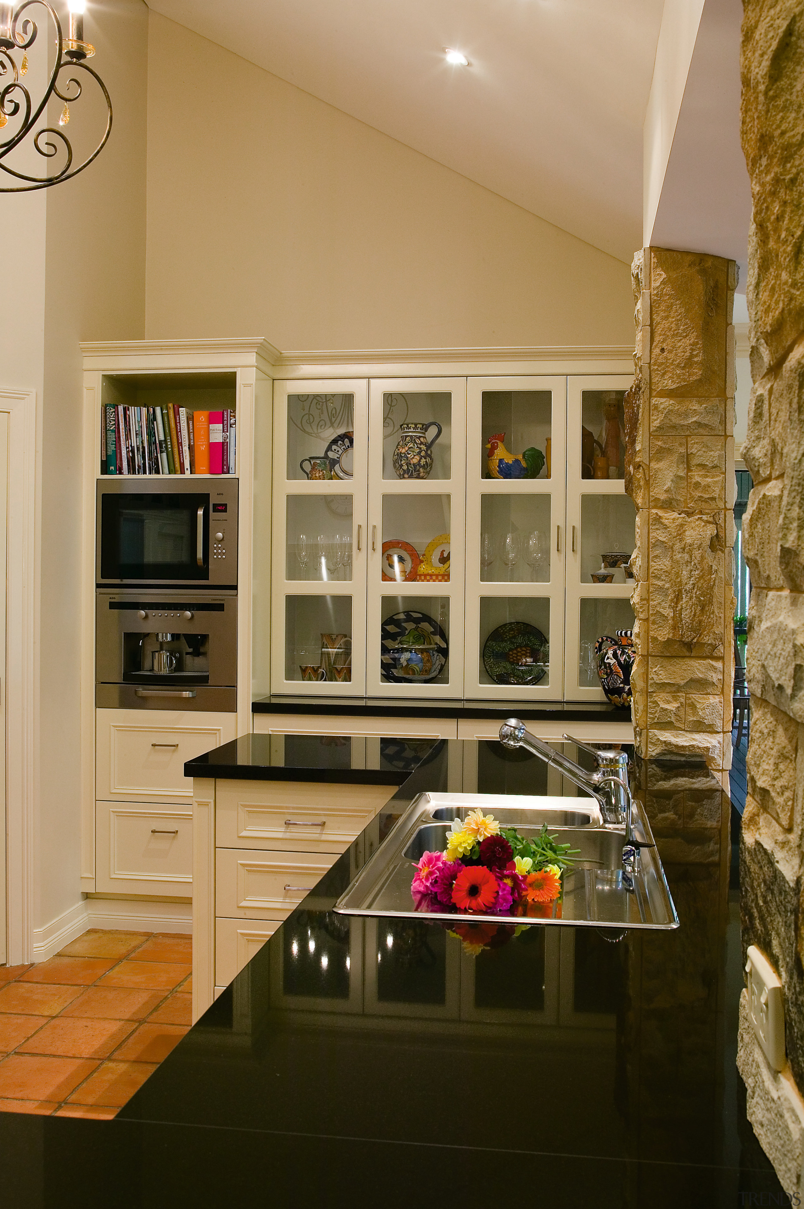 view of this french influenced kitchen featuring glass cabinetry, countertop, interior design, kitchen, room, brown, orange