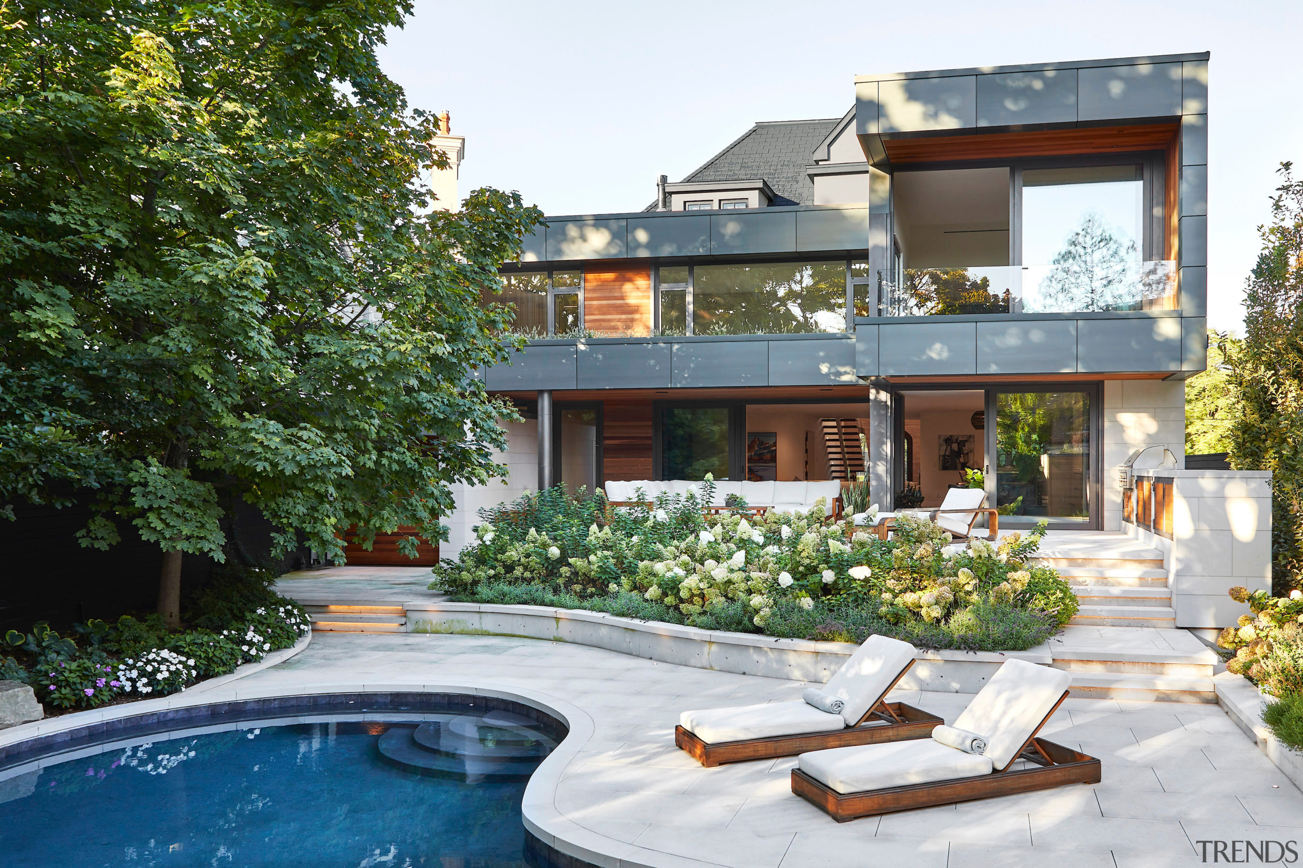 Rear yard showcases a stunning contemporary addition that 