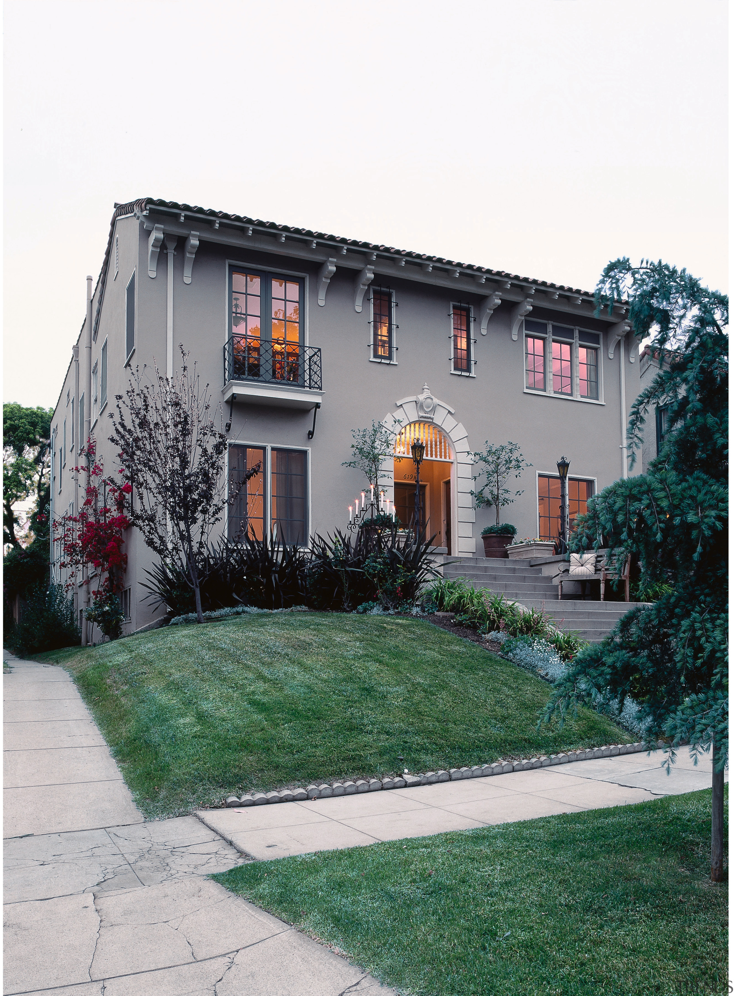 view of this 1920s apartment featuring wrought iron building, estate, facade, home, house, neighbourhood, property, real estate, residential area, siding, window, white