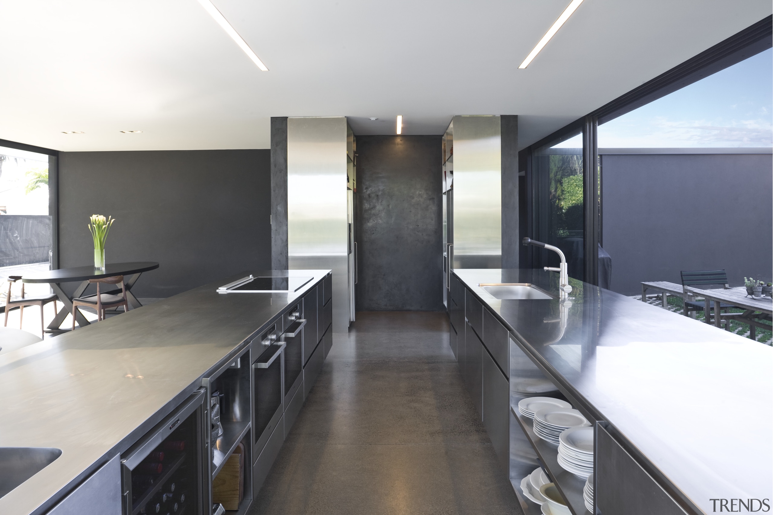 View of open-plan kitchen featuring polished concrete flooring, countertop, house, interior design, kitchen, property, real estate, white