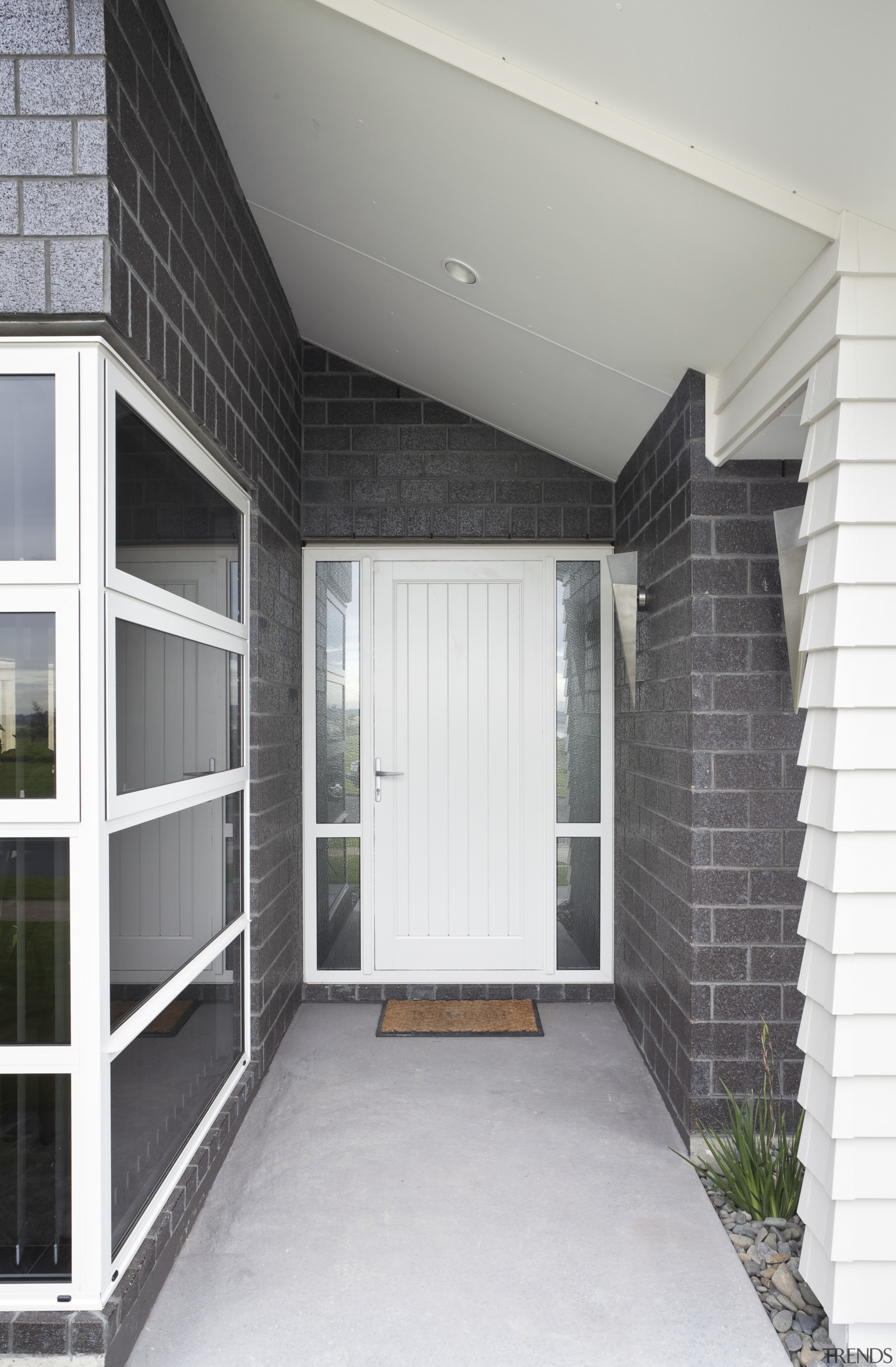 Exterior of single-storey house, dark stone cladding, and architecture, door, facade, home, house, real estate, siding, window, gray