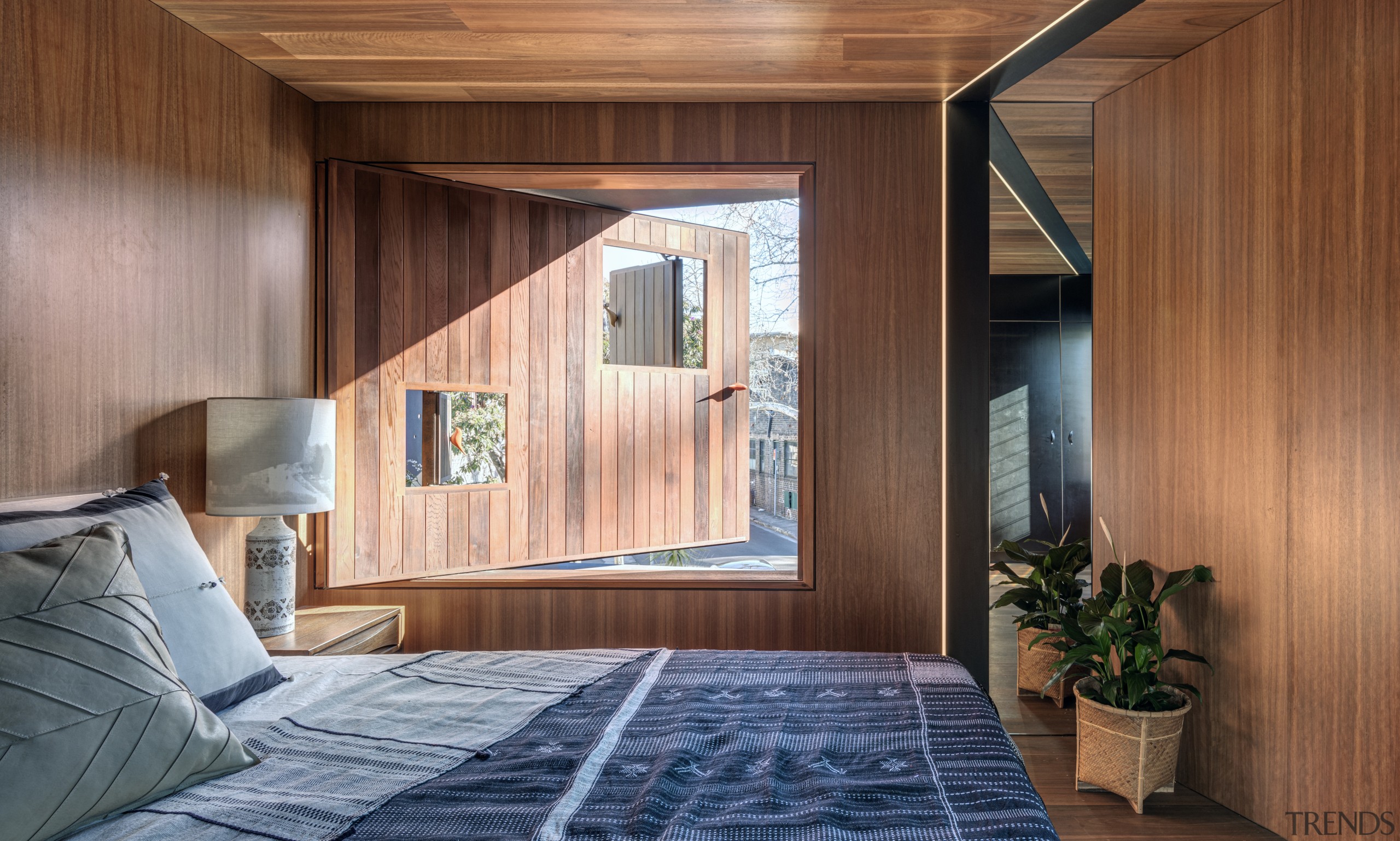 ​​​​​​​Overlooking the street, this bedroom needed to balance brown, gray